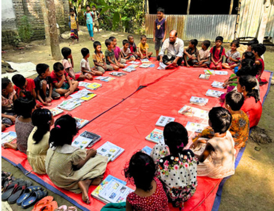 Children sitting in a circle studying at an ENRICH Learning Center