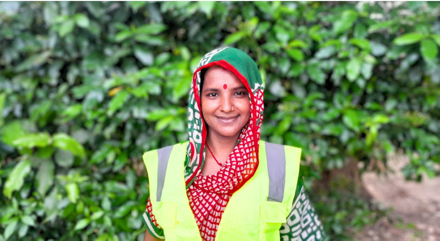 Smiling female sanitation worker in safety apron and traditional attire