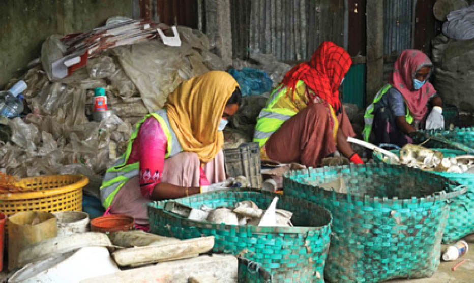 Women waste workers sorting recyclable plastic materials outdoors