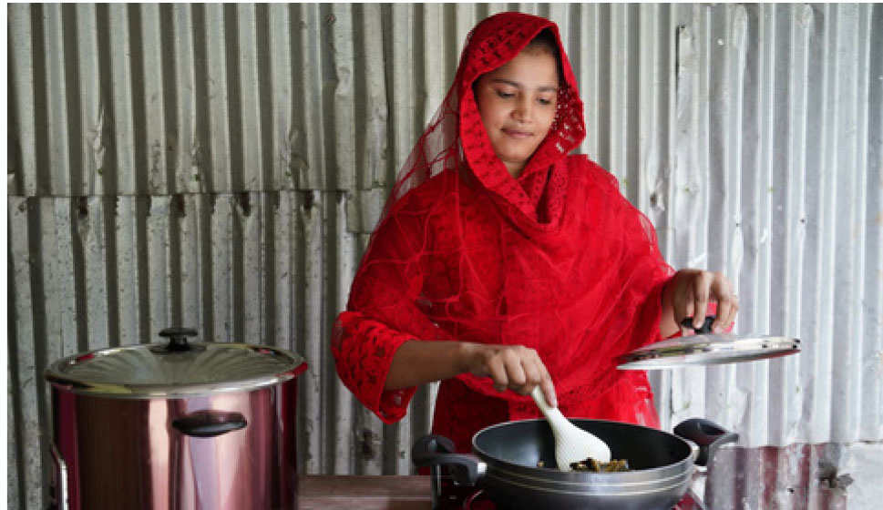 Woman smiling while preparing food on a modern clean cooking stove