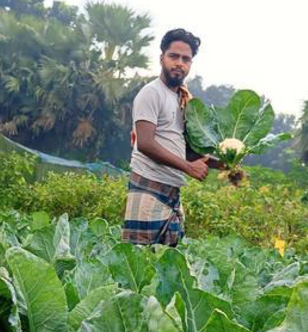 Sohel holding cauliflower harvest